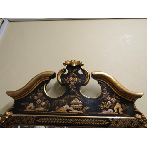 1370 - An 18th century style wall mirror with chinoiserie detail frame in black and gilt, set beneath a mou... 