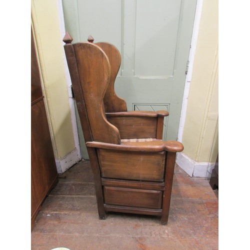 1482 - An old English style oak lambing type chair with winged and fielded panelled back over a drawer base