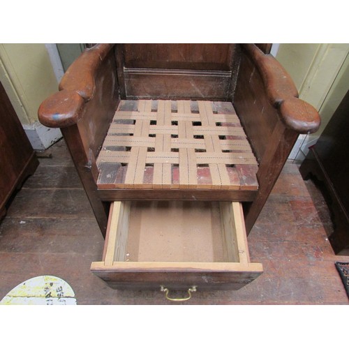 1482 - An old English style oak lambing type chair with winged and fielded panelled back over a drawer base