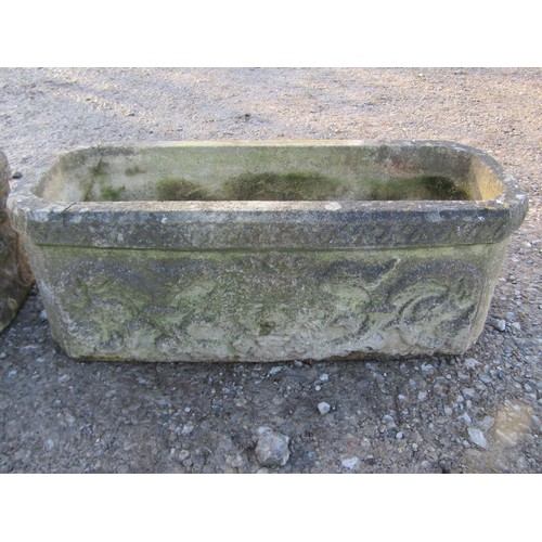 22 - A pair of weathered rectangular cast composition stone flower troughs with canted corners, lions mas... 