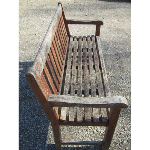 46 - A pair of good quality heavy gauge weathered teak three seat garden benches with slatted seats and b... 