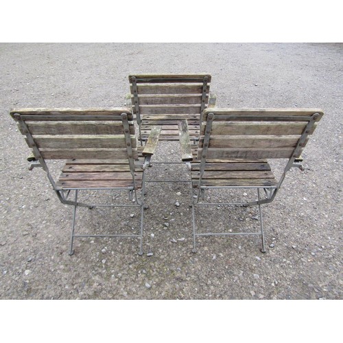 48 - A set of three folding steel framed garden open armchairs with weathered timbered slats, 63 cm wide ... 