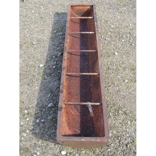 77 - An old cast iron rectangular pig trough with five simple rung divisions, 181cm long x 32cm wide x 17... 