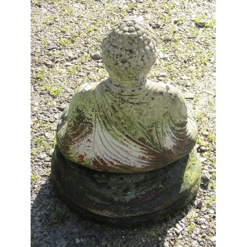 78 - A cast composition stone garden ornament in the form of a seated Buddha in lotus position, raised on... 