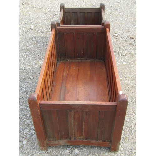 81 - A pair of stained and weathered teak garden planters with facetted square cut supports and slatted p... 