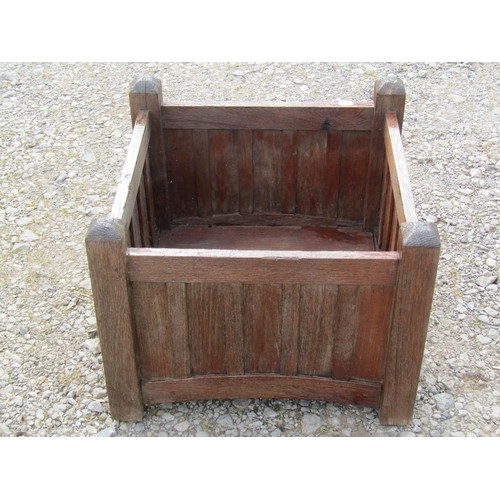 81 - A pair of stained and weathered teak garden planters with facetted square cut supports and slatted p... 