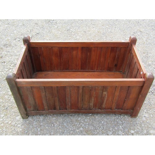 81 - A pair of stained and weathered teak garden planters with facetted square cut supports and slatted p... 