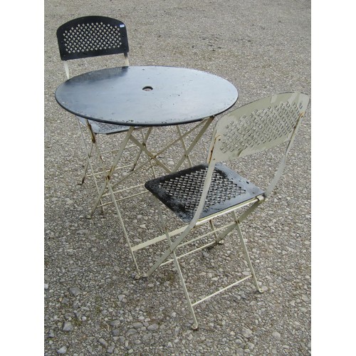 82 - A painted folding steel three piece Bistro set with lattice detail, the table 77cm diameter (af)