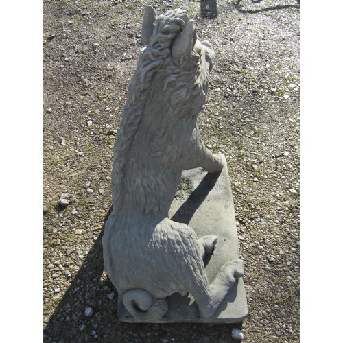 63 - A life size cast composition stone garden ornament/study of a seated wild boar set on a rectangular ... 