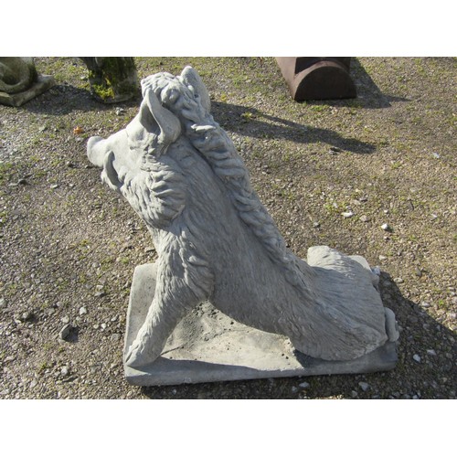 63 - A life size cast composition stone garden ornament/study of a seated wild boar set on a rectangular ... 