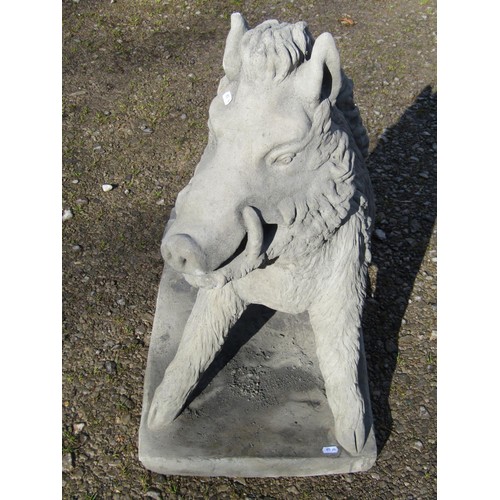 63 - A life size cast composition stone garden ornament/study of a seated wild boar set on a rectangular ... 