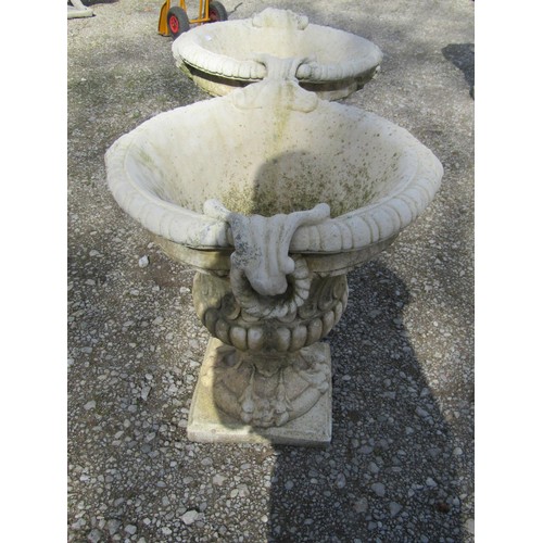 64 - A pair of large weathered cast composition stone garden urns with lobed bodies, fixed ring handles, ... 