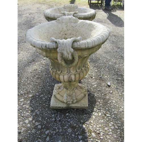 64 - A pair of large weathered cast composition stone garden urns with lobed bodies, fixed ring handles, ... 