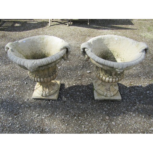 64 - A pair of large weathered cast composition stone garden urns with lobed bodies, fixed ring handles, ... 