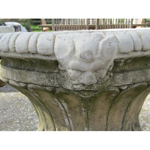 64 - A pair of large weathered cast composition stone garden urns with lobed bodies, fixed ring handles, ... 