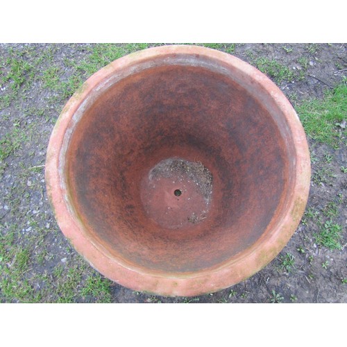 65 - A pair of large weathered terracotta planters of circular tapered and simple ribbed form, 56 cm high... 