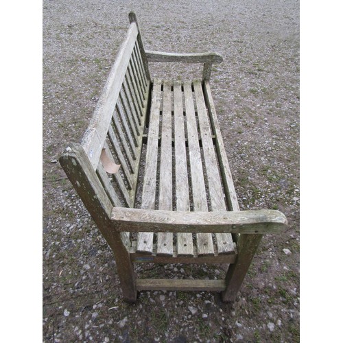 87 - A weathered teak Tiger Trading three seat traditional garden bench with slatted seat and back, 153cm... 