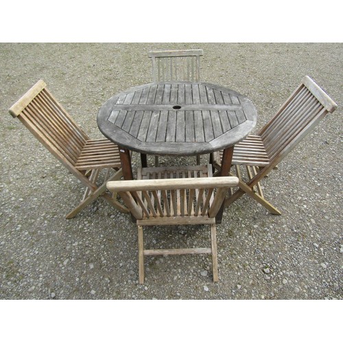 91 - A small weathered teak garden table with circular slatted top, raised on square cut supports, 100cm ... 