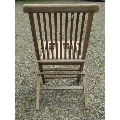 91 - A small weathered teak garden table with circular slatted top, raised on square cut supports, 100cm ... 