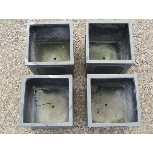 69 - Four moulded fibre glass to simulate lead square cut planters with repeating panels 27 cm square