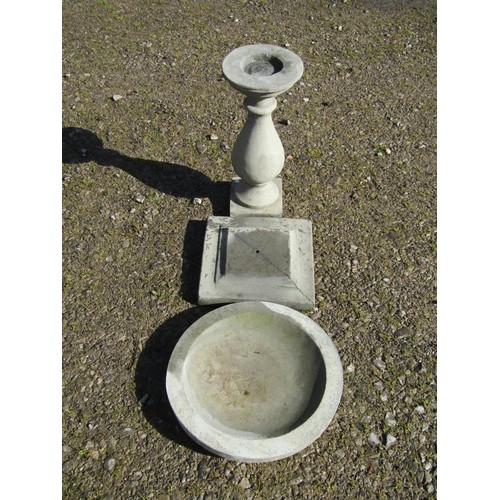 92 - A cast composition stone three sectional bird bath of circular form raised on a baluster pedestal an... 