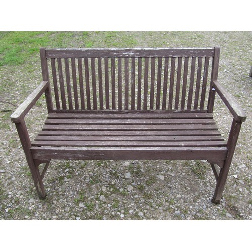 70 - An associated suite of garden furniture comprising a weathered teak table with rectangular slatted p... 