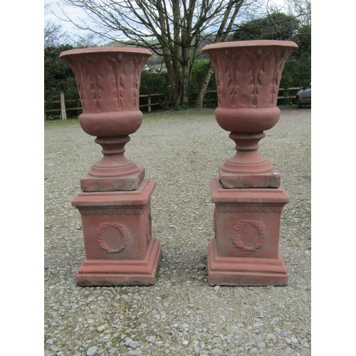 72 - A pair of faux terracotta cast composition stone trumpet shaped garden urns with repeating leaf patt... 