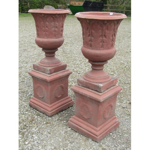 72 - A pair of faux terracotta cast composition stone trumpet shaped garden urns with repeating leaf patt... 