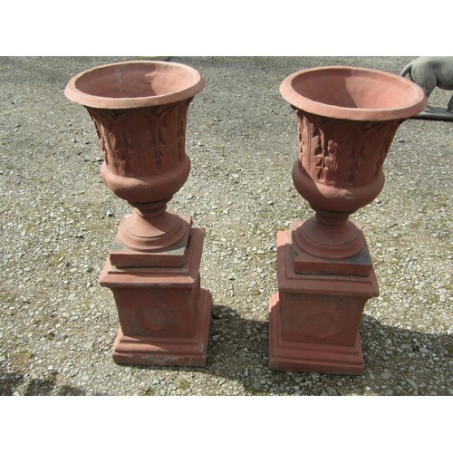 72 - A pair of faux terracotta cast composition stone trumpet shaped garden urns with repeating leaf patt... 