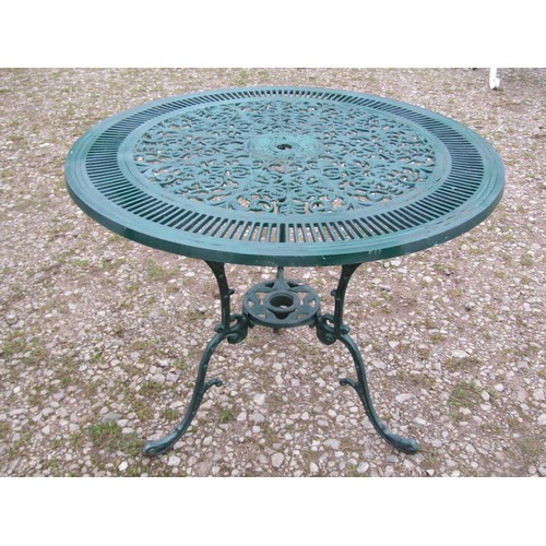 100 - A green painted cast aluminium garden terrace table of circular form, with decorative pierced top, t... 