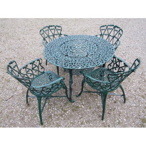 101 - A green painted cast alloy circular two tier garden terrace table, with decorative repeating 'c' scr... 