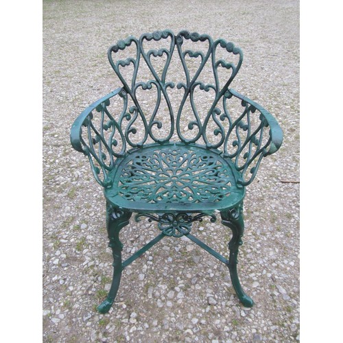 101 - A green painted cast alloy circular two tier garden terrace table, with decorative repeating 'c' scr... 