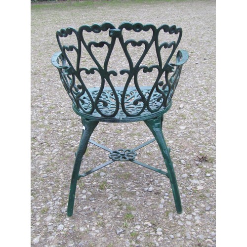 101 - A green painted cast alloy circular two tier garden terrace table, with decorative repeating 'c' scr... 