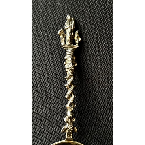 208A - An 18th century Dutch silver christening spoon with shaped and pierced handle, surmounted by Madonna... 