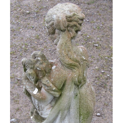 114 - A weathered cast composition stone garden ornament in the form of a standing classical maiden clutch... 