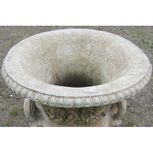 130 - A large cast composition stone campana shaped garden urn with repeating scrolling foliate relief det... 