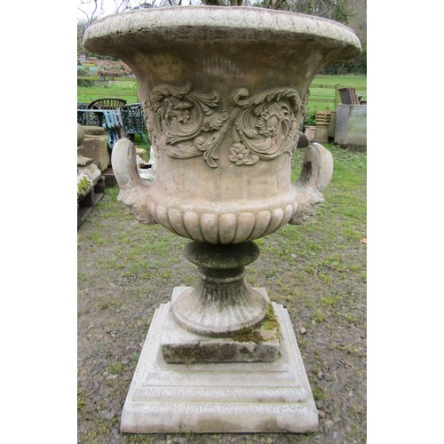 130 - A large cast composition stone campana shaped garden urn with repeating scrolling foliate relief det... 