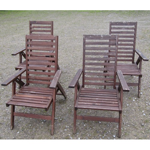 151 - A set of four stained and weathered contemporary folding hardwood garden armchairs with slatted seat... 