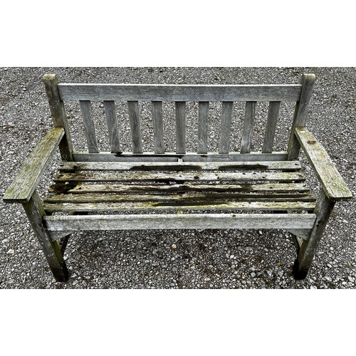 157 - A weathered two seat garden bench with slatted seat and back (unmarked) but possibly a Lister exampl... 