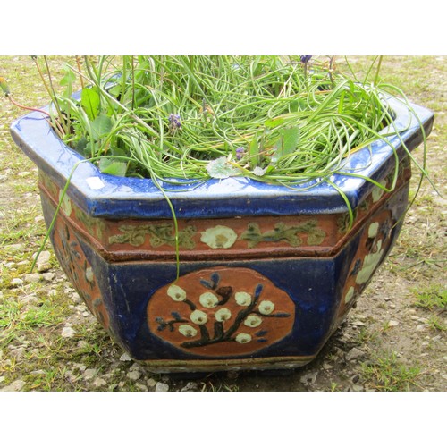 170 - A predominantly blue glazed hexagonal Chinese style glazed planter with foliate relief panels 37 cm ... 