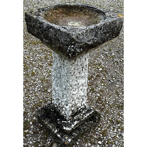 A five sectional cast to simulate rough hewn stone garden  bird bath of square cut and stepped form, the dished top 37 cm square x 91 cm (full height)