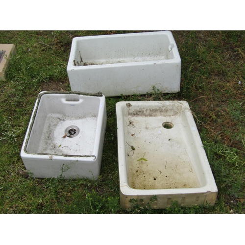 Three reclaimed white glazed butlers sinks of varying size and design, the largest 76 cm long x 50 cm wide x 27 cm deep (af)