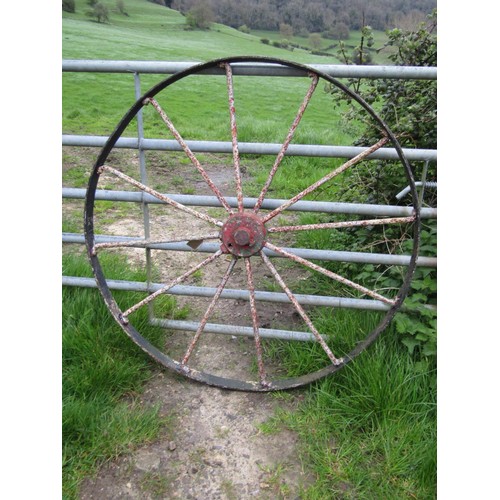 182 - A large antique iron implement wheel with traces of layers of painted finish 122 cm (4ft diameter)