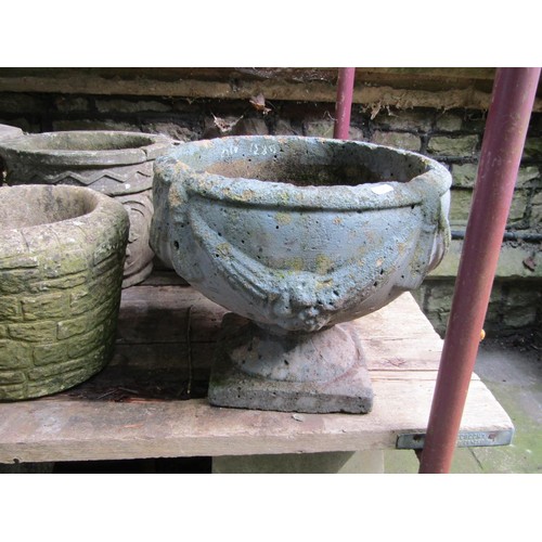 205 - A collection of cast composition stone planters, various designs and sizes, together with two shallo... 