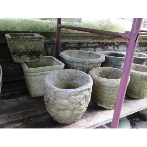 205 - A collection of cast composition stone planters, various designs and sizes, together with two shallo... 