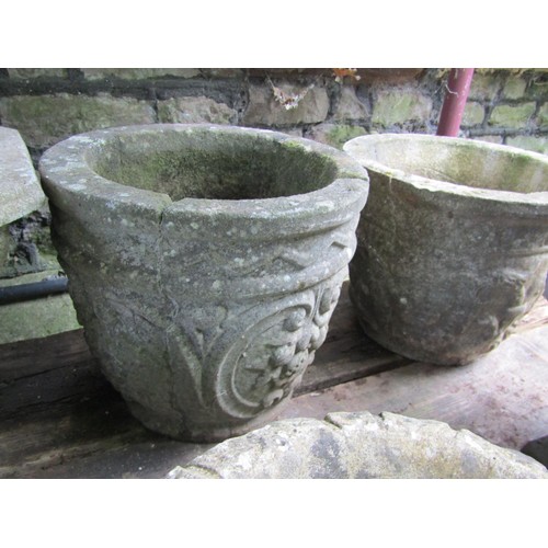 205 - A collection of cast composition stone planters, various designs and sizes, together with two shallo... 