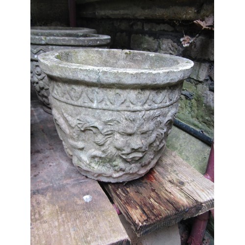 205 - A collection of cast composition stone planters, various designs and sizes, together with two shallo... 