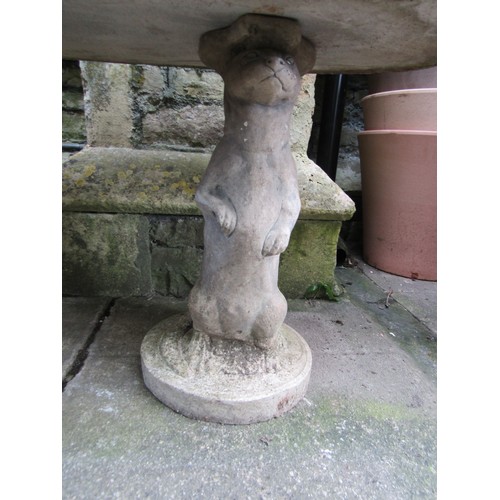 207 - A novelty weathered three sectional composition stone garden table with oval top on standing otter s... 