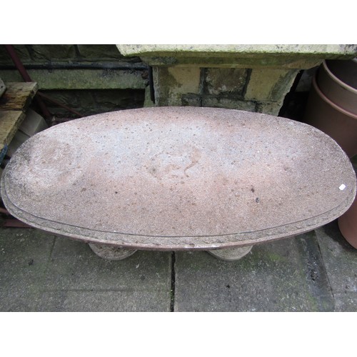 207 - A novelty weathered three sectional composition stone garden table with oval top on standing otter s... 