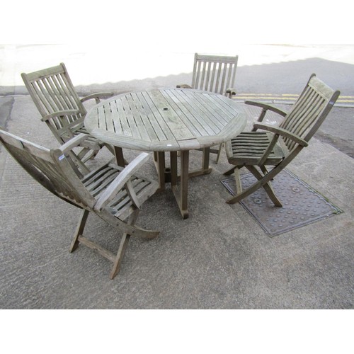 276 - A Canterbury Collection weathered teak circular folding gateleg garden table and four matching armch... 